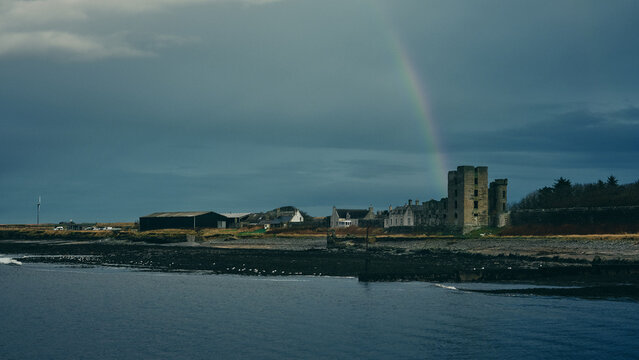 rainbow over the river and town by rivermouth in stormy weather