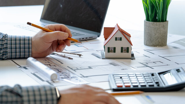 Hand sketches house plans on paper