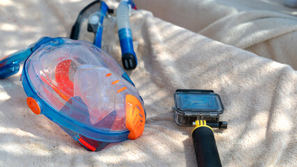 Bright snorkel mask rests on soft towel © I