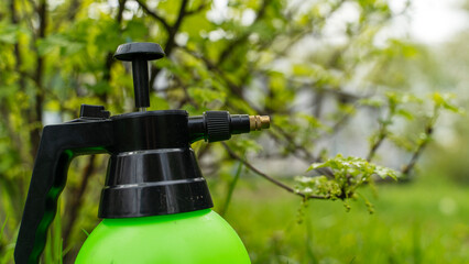 Green sprayer stands ready for garden work © I