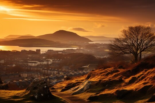 Edinburgh cityscape and firth of forth glowing under warm golden hour sunset light