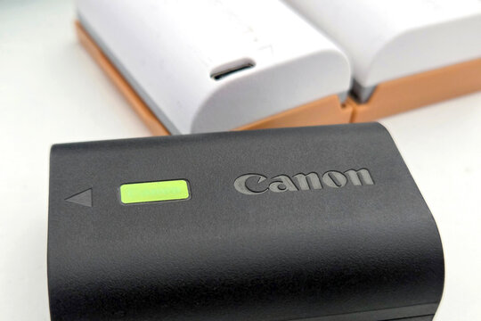 Wroclaw, Poland, April 29, 2026: Canon Camera Battery with Two Charging Units for Photography Equipment