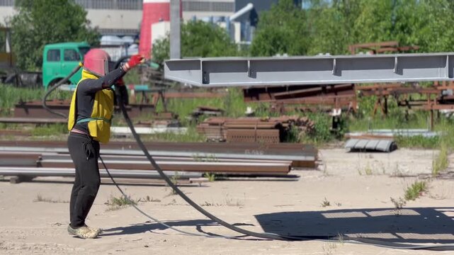 man with sandblaster