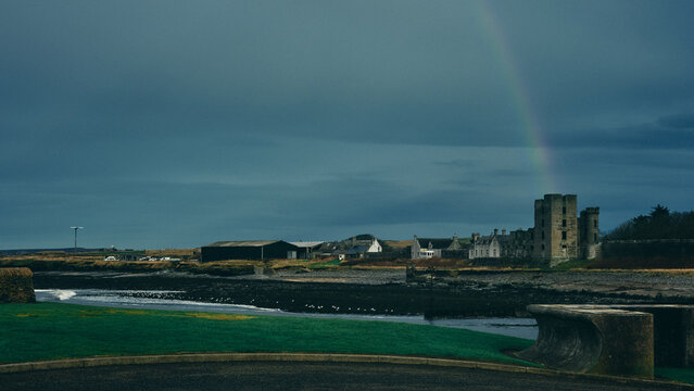 rainbow over the river and town by rivermouth in stormy weather