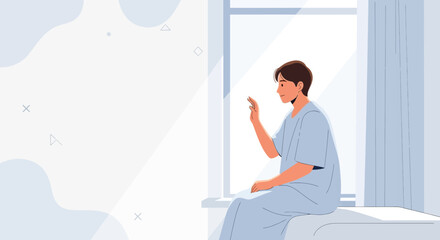 Fototapeta premium Young Man in Hospital Gown Texting on Phone by Sunny Window