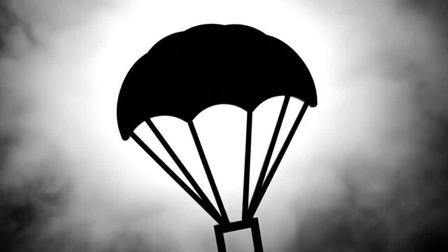 Black and white silhouette of a parachute against a cloudy sky with a bright light in the background
