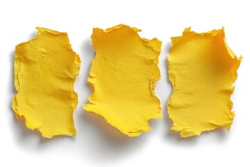 Naklejka premium Three torn bright yellow textured paper scraps on a white background