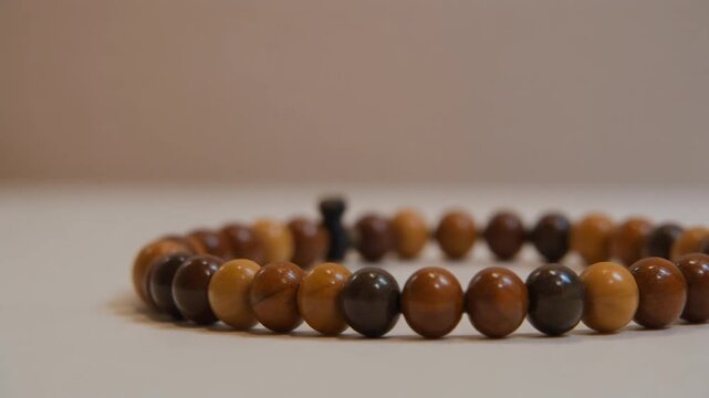 Close-up shot of a wooden beaded bracelet with a soft, blurred background, showcasing natural wood grain and texture