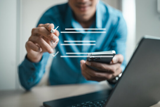 Business professional using smartphone and laptop with digital checklist interface, representing online approval, survey response, task planning, evaluation and smart workflow management.