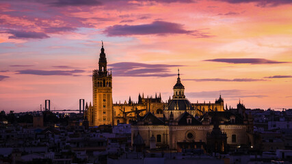 Naklejka premium The Sunset Glow over the Seville Cathedral and Giralda Tower