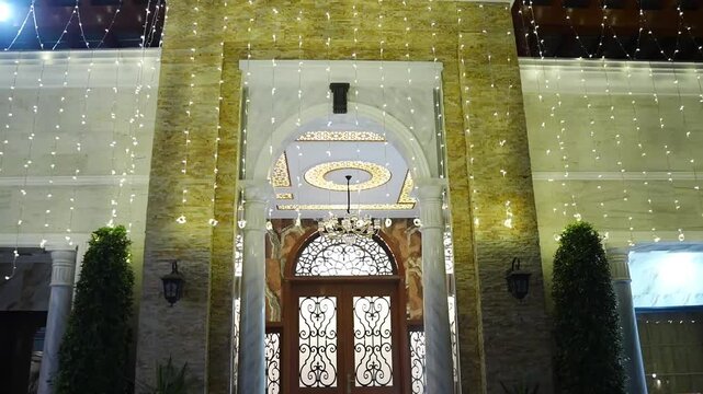 Luxury Wedding Hall Entrance with Decorative Fairy Lights at Night
