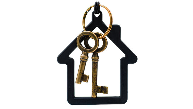 Two antique brass keys on a gold ring hanging from a black house-shaped keychain, isolated on transparent background