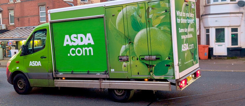 Leicester, England, UK - 9 May 2026: ASDA delivery van on city street, green grocery home delivery truck with branding and apples graphics in United Kingdom