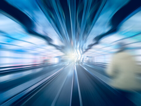 Abstract shot of a traveller rushing through a tunnel at an airport terminal