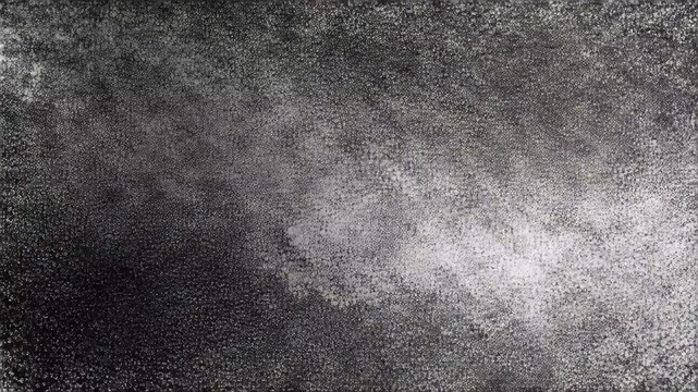 Abstract texture of black and white speckles shows random patterns that create a visual effect of depth and movement in a digital space