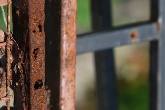 heavy rust and corrosion on an old metal gate