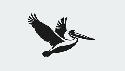 Fototapeta premium Silhouette of a pelican bird in flight with wings spread wide.