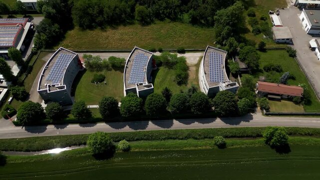 Industrial facilities with rooftop solar panels near Lombardy, Italy. Modern environmental technology and sustainable infrastructure complex.