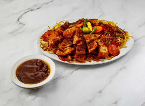 Special pancit noodles with crispy lechon pork and savory sauce served Filipino style