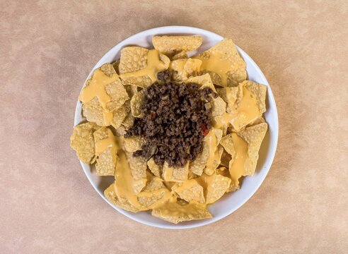 Crunchy tortilla chips topped with cheese sauce and seasoned beef