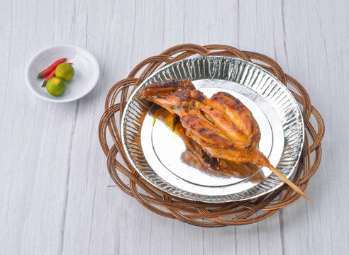 Grilled chicken breast barbecue served with calamansi and chili peppers
