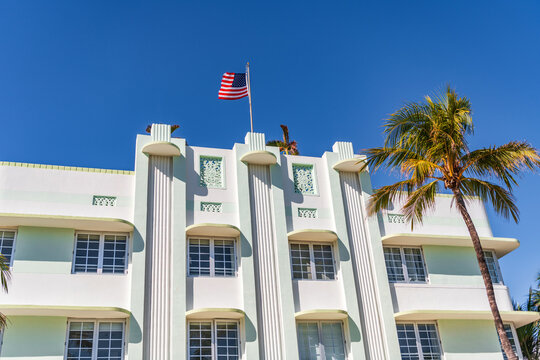 Modern building of Miami beach with USA flag. Ocean drive. Miami Beach in Ocean Drive, USA. Art Deco building architecture. Architectural building. Art deco. Architectural district Art Deco