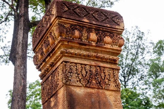 Carved pink sandstone pillar capital at Banteay Srei temple, Angkor.