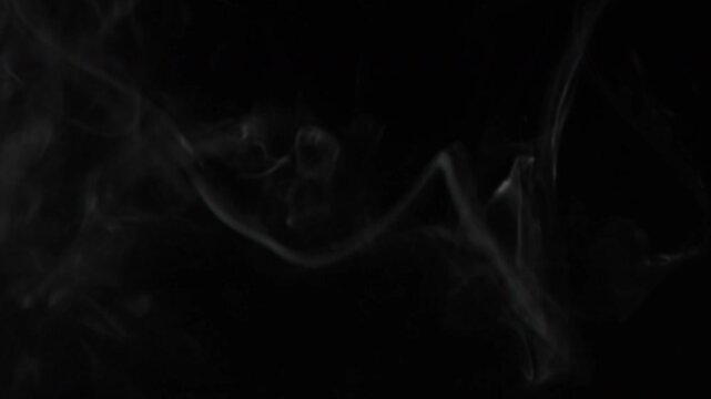 Realistic White Smoke Steam or Vapor Rising and Swirling Against a Black Background.