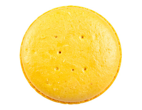 Round yellow cheese cracker biscuit with small holes crispy baked surface and savory snack texture on isolated background