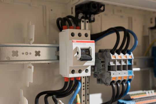 DRESDEN, GERMANY - 17. February 2026: ABB E463 3KB main switch in domestic fuse box. On-off switch mounted on DIN rail. Close-up of electrical component in housing technology.