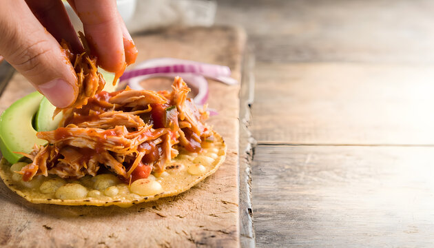 Layering Chicken Tinga Tostadas with Avocado and Onion Close-Up