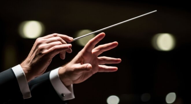 Orchestra Conductors Hands Leading Music Performance with Baton.