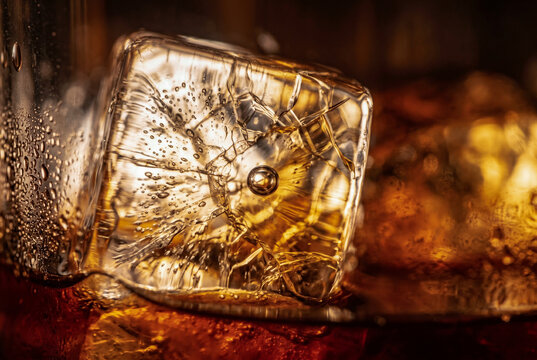 Extreme macro of cracked ice in a golden liquid. Intricate internal fractures, air bubbles, and amber glow. Masterpiece of light refraction and texture.
