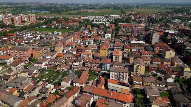 Aerial view of Pantigliate, a rural municipality southeast of Milan surrounded by agricultural fields, irrigation canals, and transport infrastructure in Lombardy, Italy.