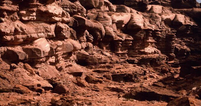 Close-up rocky desert formations display detailed sandstone textures and layered erosion patterns.