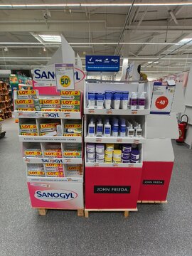 Royan, France - May 10, 2026: E.Leclerc. Sanogyl and John Frieda product display in retail store featuring promotional signage and various hair care items on shelves