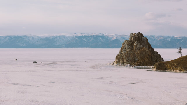Winter landscape with Shaman Rock rising above the frozen surface of Lake Baikal, near Khuzhir village on Olkhon Island, Irkutsk Oblast, Russia