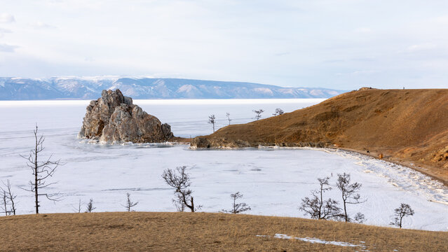 Winter landscape with Shaman Rock (Shamanka) on the frozen surface of Lake Baikal near Khuzhir village, Olkhon Island, Irkutsk Oblast, Russia