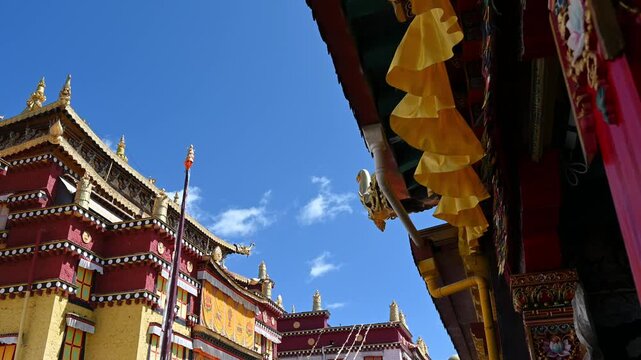 Cinematic Low-Angle Shot in Songzanlin Temple Square - Looking Up at Gilded Facades, Yunnan China