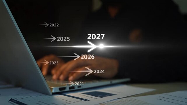 Businessman working on laptop with touching a holographic 2027 year, A man touching virtual screen with 2027