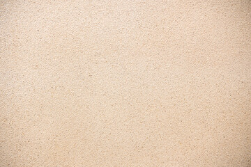 Fototapeta premium Beige sand wall texture background. Abstract grainy plaster surface for architectural design and construction backdrop. Natural light brown cement or stone finish with fine detailed material.