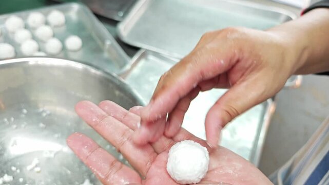 Step of wrapping sweet minced pork filling with sago or tapioca pearls.