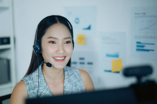 Customer service woman with headset talks at computer in office, showing online support and call center work.