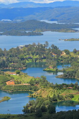Fototapeta premium Aerial View of Guatapé Lake with Green Islands and Traditional Village, Antioquia, Colombia
