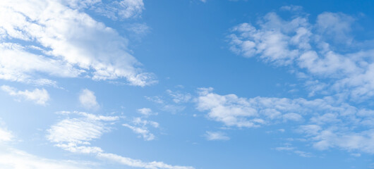 Fototapeta premium Low angle view and full frame of beautiful blue sky with strange shape of fluffy white clouds in the afternoon on sunny day used as natural background texture in decorative art work