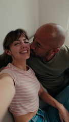 Fototapeta premium Couple At Home Laughing And Kissing