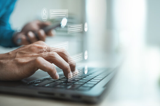 Customer support agent using laptop with virtual live chat interface, representing online assistance, instant messaging, CRM service, AI chatbot communication, help desk response.
