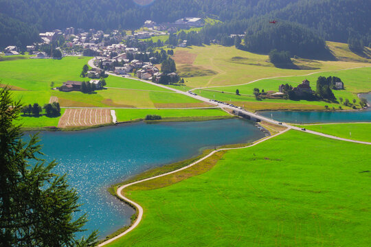 Aerial view of the green area near the Alpine lake and village of Silvaplana. Upper Engadine valley, Canton of Graub&uuml;nden (Grisons), Switzerland