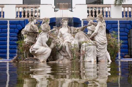 Fountain with stone-carved statues in the Bacalhoa Buddha Eden garden - Portugal