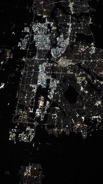 Vertical flying over Calgary city lights at night satellite view from space based on Nasa imagery